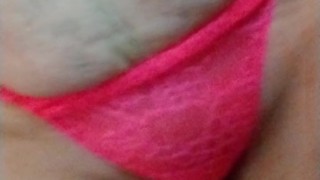 Smoking in neon pink lace bra and panties